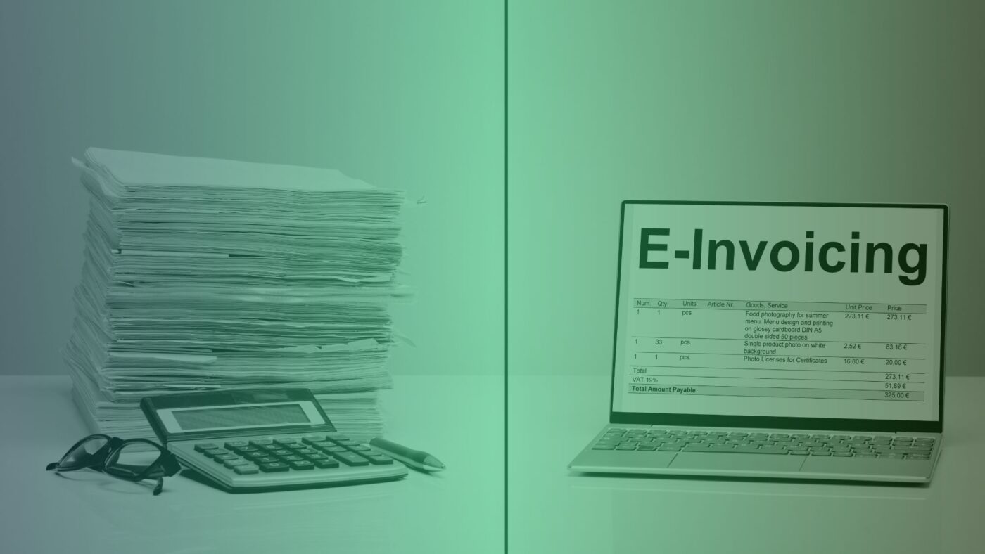 Papierrechnungen als Symbols für bisherige Rechnungen und ein Laptop mit einer E-Rechnung